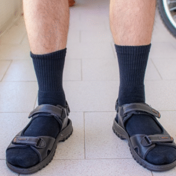 shot of man wearing socks and sandals
