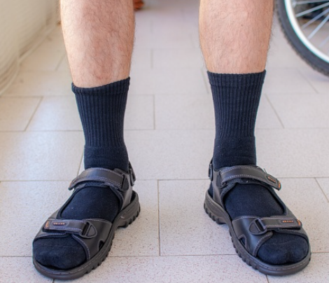 shot of man wearing socks and sandals